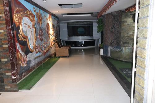 a hallway with a mural on the walls of a room at Hotel SK Riverfront in Vijayawāda