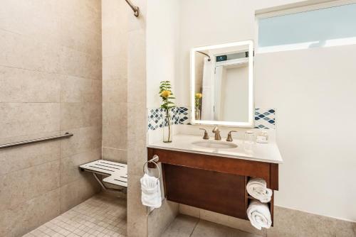 a bathroom with a toilet, sink, and mirror at Islander Resort in Islamorada
