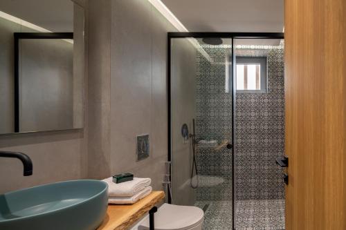 a bathroom with a sink and a toilet and a shower at Hermes Grand Luxury Beachfront Villa & Spa, By ThinkVilla in Skaleta