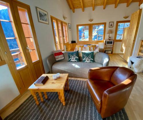 a living room with a couch and a coffee table at Chalet Amos in Grimentz