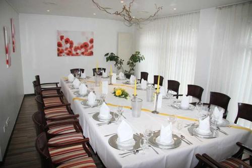 a long table in a room with chairs at Vorsfelder Hof in Wolfsburg