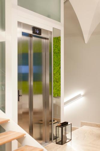 an elevator with a sign on it in a building at NITI Palace in Castellammare del Golfo