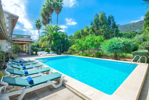 a swimming pool with chaise lounge chairs and a resort at Owl Booking Villa La Font - Relax with a Big Pool in Pollença