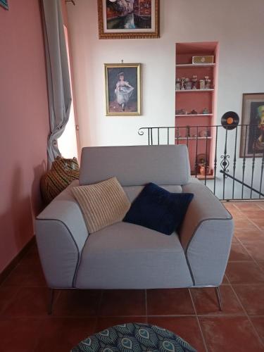 a gray couch in a living room at La Torre di Barbara in Ardea