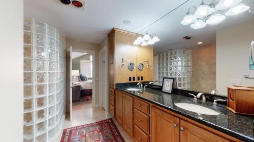 a bathroom with two sinks and a large mirror at 2 Off Shore in Hilton Head Island