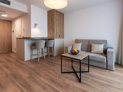 a living room with a couch and a table at VacationClub – Jantaris Apartament B34 in Mielno