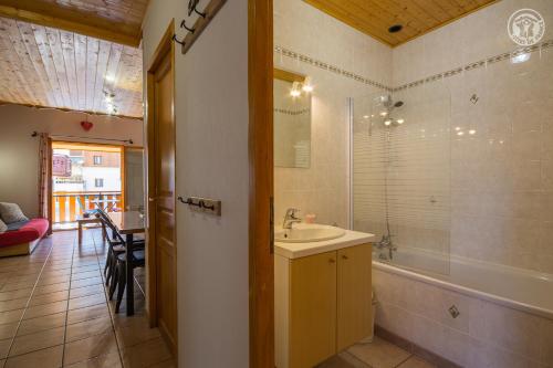 a bathroom with a sink and a tub and a shower at La Tomba Val-Cenis Lanslevillard in Lanslevillard