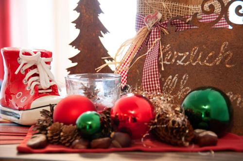 a table topped with christmas ornaments on a table at Ferienwohnungen Wendelstein in Bad Feilnbach