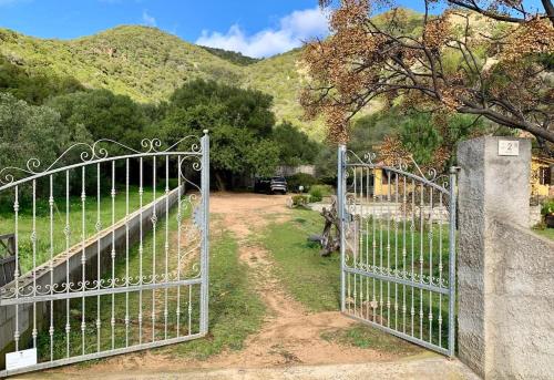 a gate to a driveway with a mountain in the background at Villa Magnolia in Chia