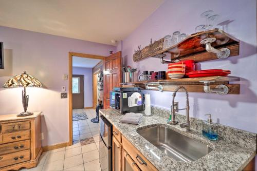 a kitchen with a sink and a microwave at Cozy Mtn Getaway - Steps to Beech Mountain Resort! in Beech Mountain