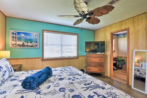 a bedroom with a bed and a ceiling fan at Colorful Crystal Beach Home with Ocean View! in Crystal Beach