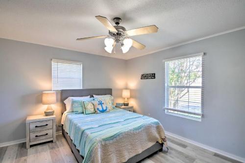 a bedroom with a bed and a ceiling fan at Gulf Breeze Home 12 Mi to Pensacola Beach! in Oriole Beach