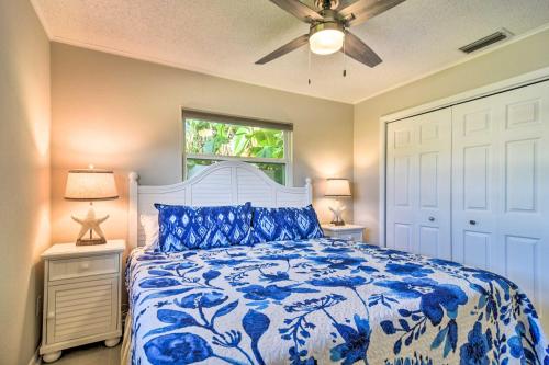 a bedroom with a blue and white bed with a ceiling fan at Indian Rocks Beach Home - 2 Blocks to Beach! in Clearwater Beach