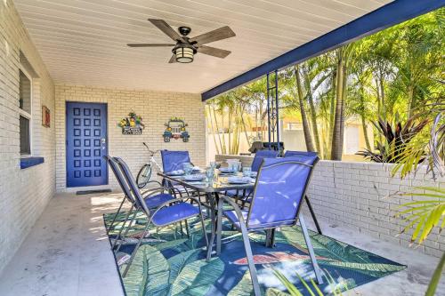 a patio with blue chairs and a table at Indian Rocks Beach Home - 2 Blocks to Beach! in Clearwater Beach