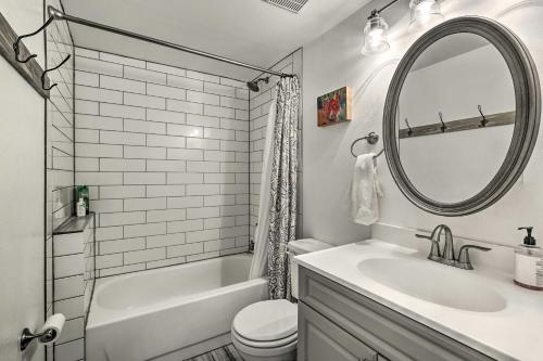a white bathroom with a sink and a mirror at Condo with Balcony and Views - Steps to Ski Shuttle! in Fraser