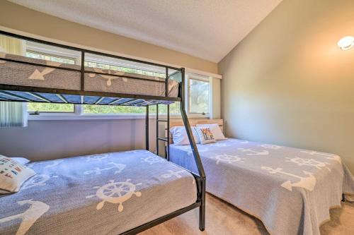 a bedroom with two bunk beds and a window at Harbor Springs Condo with Fireplace Near Skiing! in Harbor Springs