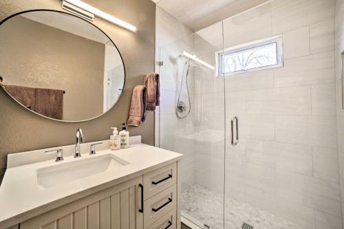 a bathroom with a shower and a sink and a mirror at Chic Reno Home with Game Room and Putting Green! in Reno