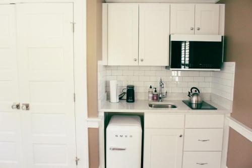 a kitchen with white cabinets and a sink at Mary's Land Farm in Ellicott City