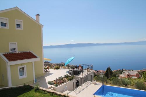 a view of a house and a swimming pool at Villa Lilly in Podgora