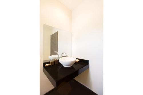 a bathroom with a sink and a mirror at Villa Iorangi| 3 Bedroom Private Pool Residence in Rawai Beach in Rawai Beach