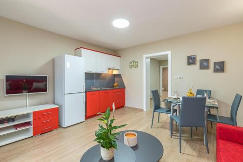 a living room with a kitchen and a dining room at Apartment Complex Irena with Pool in Poreč