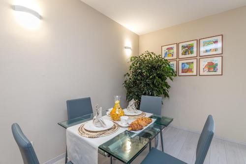 a dining room with a table with a plate of food on it at Apartment Complex Irena with Pool in Poreč