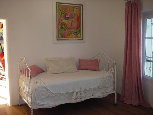 a white bed with two pillows in a room at Pavillon de Beauregard in Aix-en-Provence