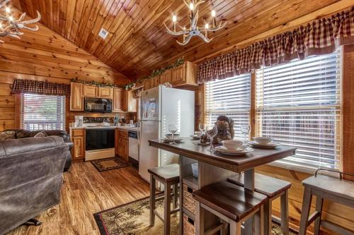 a kitchen and living room with a table and a refrigerator at The Nut House, Hot Tub, Game Room, WIFI, 560 FREE tickets each paid day in Pigeon Forge