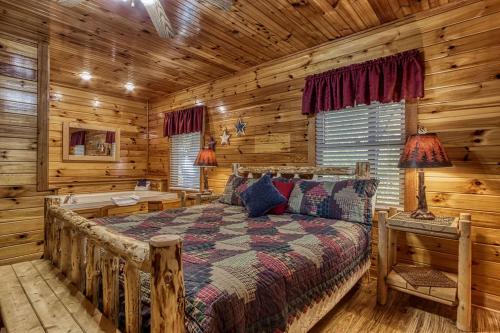 a bedroom with a bed in a log cabin at The Nut House, Hot Tub, Game Room, WIFI, 560 FREE tickets each paid day in Pigeon Forge