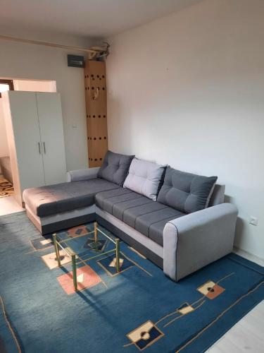a living room with a large couch in a room at Apartman Vuk in Pale