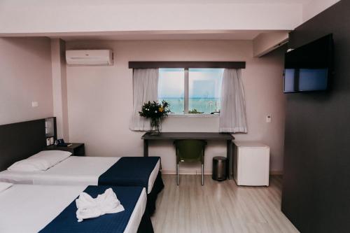 Postel nebo postele na pokoji v ubytování Pajuçara Hotel Express