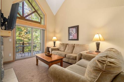 a living room with a couch and a tv at Gull Lake All-Season Getaway with Private Deck in Lake Shore