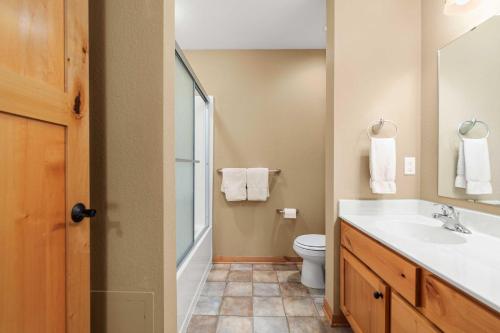 a bathroom with a sink and a toilet at Gull Lake All-Season Getaway with Private Deck in Lake Shore