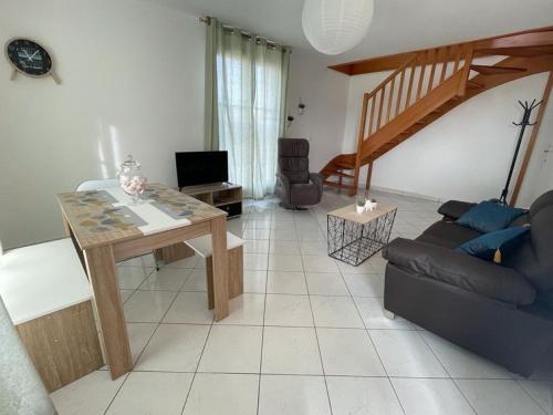 a living room with a couch and a table at Charmant appartement duplex à 5min de Disney. in Magny-le-Hongre