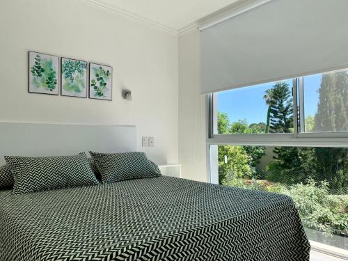 a bedroom with a bed and a large window at Milan Aparts in Colón