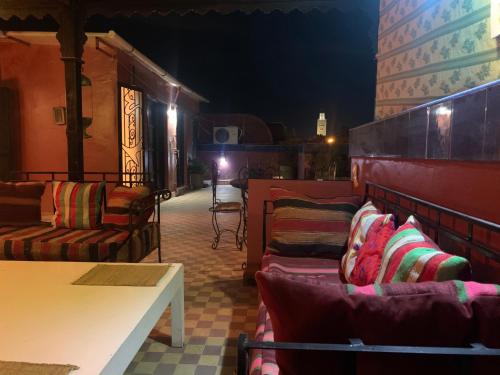 a group of chairs sitting on a patio at night at Dar el Koutoubia in Marrakech