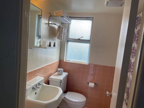 a bathroom with a white toilet and a sink at Ephrata Inn Motel in Ephrata