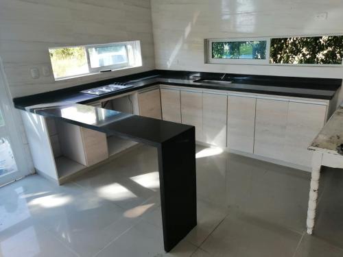 a kitchen with a black table in a room at Villa Gabriela in Agua de Dios