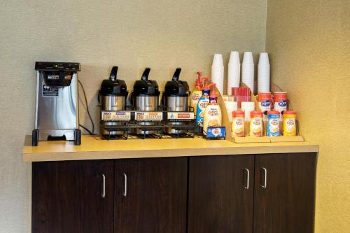 a counter with bottles of coffee and a coffee maker at Red Roof Inn PLUS+ Baltimore-Washington DC/BWI Airport in Linthicum Heights