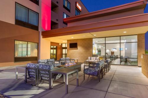 a patio with chairs and tables in a building at Best Western Plus Executive Residency Phoenix North Happy Valley in Phoenix