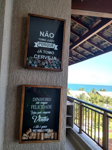 a sign on the side of a building with the ocean at Portoparadise - Beach Class Eco life Residence in Porto De Galinhas