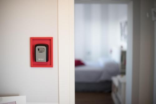 a door with a cell phone in a red box at Le terrazze di casa Bonelli in Vetralla