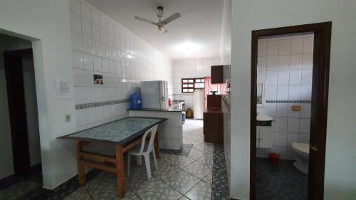 a kitchen with a table and a counter in it at Casapraia in Itanhaém