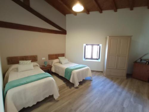 Cette chambre comprend 2 lits et une fenêtre. dans l'établissement Casa Rural Abuela Luci, 