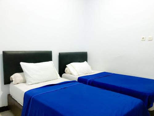 Ένα ή περισσότερα κρεβάτια σε δωμάτιο στο Wisma 88
