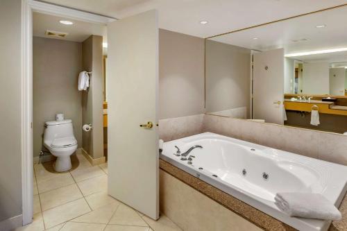 a bathroom with a bath tub and a toilet at Carriage Ridge Resort, Ascend Hotel Collection in Oro-Medonte