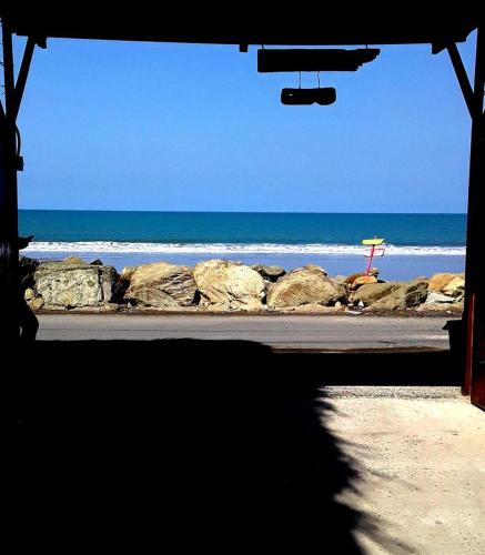 a view of a beach with rocks and the ocean at The Cottages by the Sea in San Clemente
