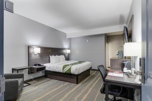 a hotel room with a bed and a desk at Quality Inn Kodak Sevierville in Kodak