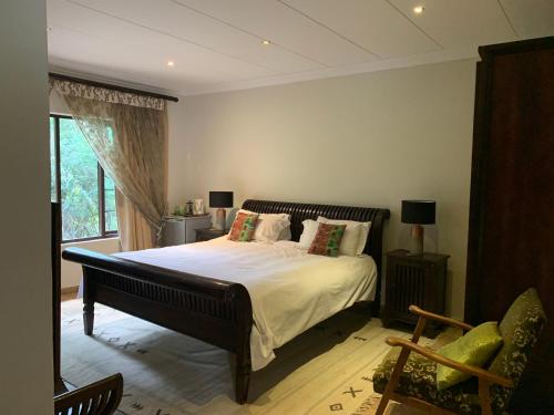 a bedroom with a large bed and a window at 42onKing in Centurion