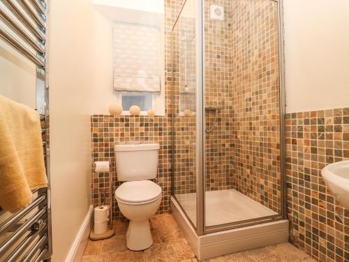 a bathroom with a toilet and a shower at Waterhead Cottage in Ambleside
